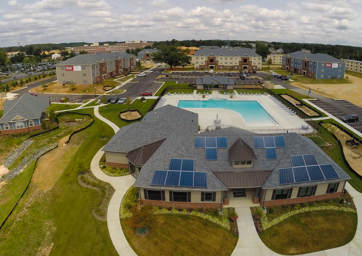 Aerial view of an apartment complex with a pool \