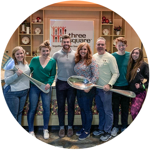 A Corvias employee and his family volunteering at a local food bank.
