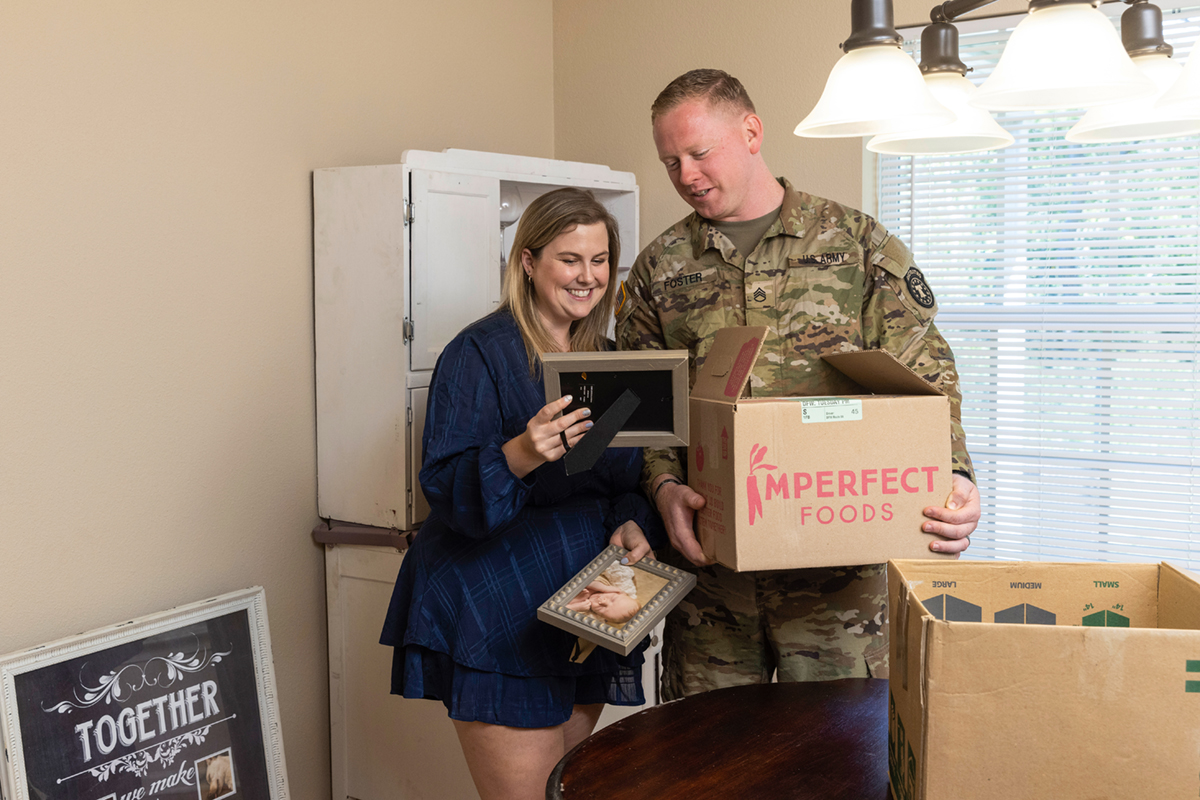 Couple unpacking a box in their new home