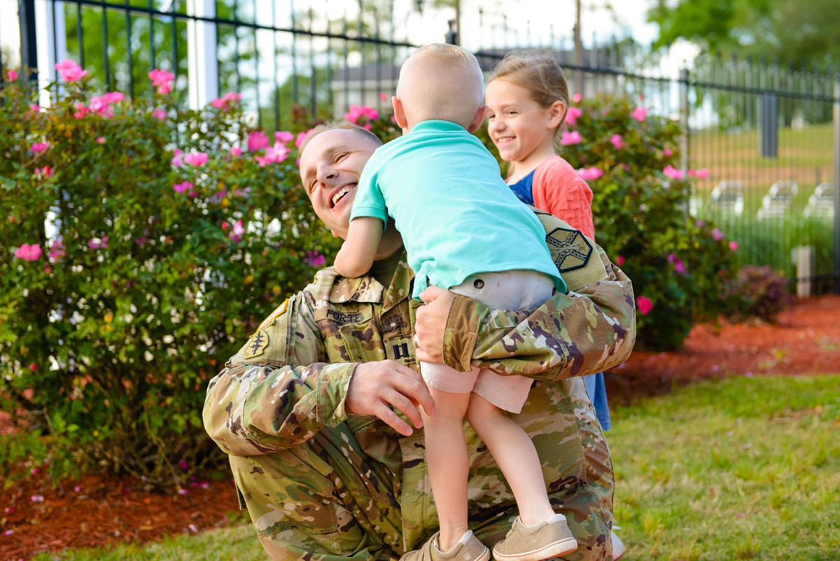 Man hugging two children