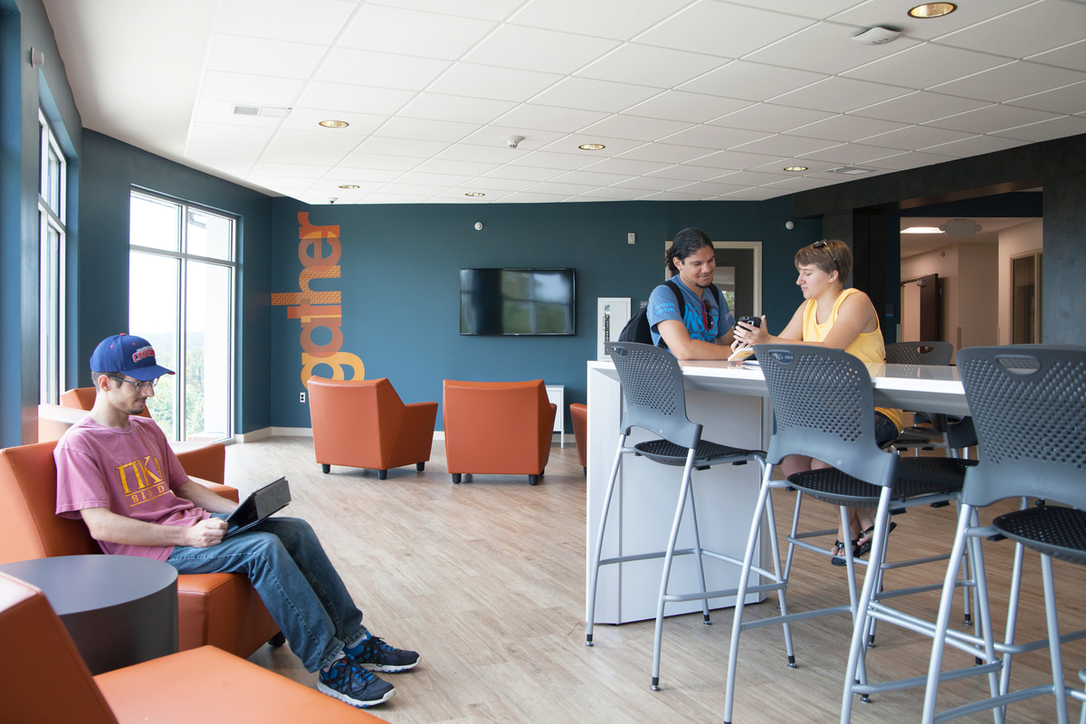 Three students working on a community room