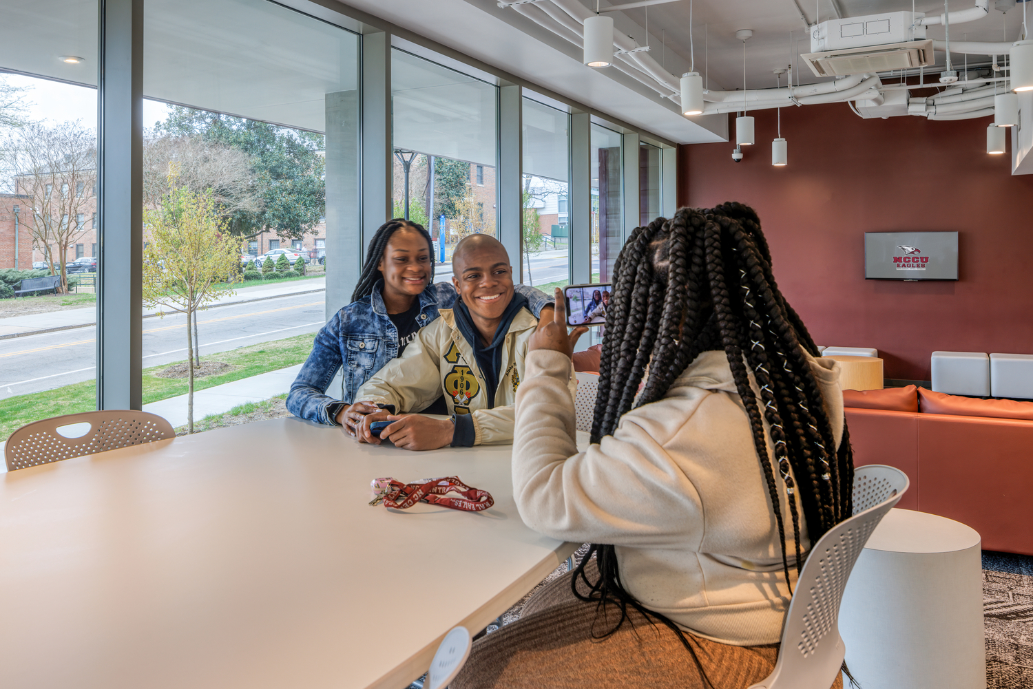 Three students sitting and talking 