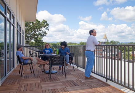 Students sitting outside on a balcony