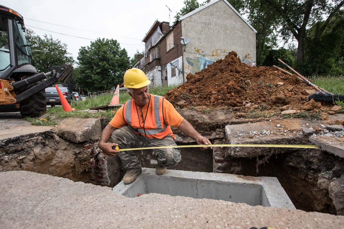 Construction worker working on sewer in Chester, PA