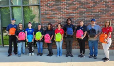 Corvias Property Management team members shop for and fill backpacks for students at Attica Elementary School in Attica, IN