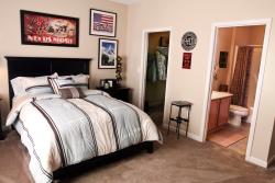 Comfortable bedrooms include private bathrooms and spacious closets for each service member.