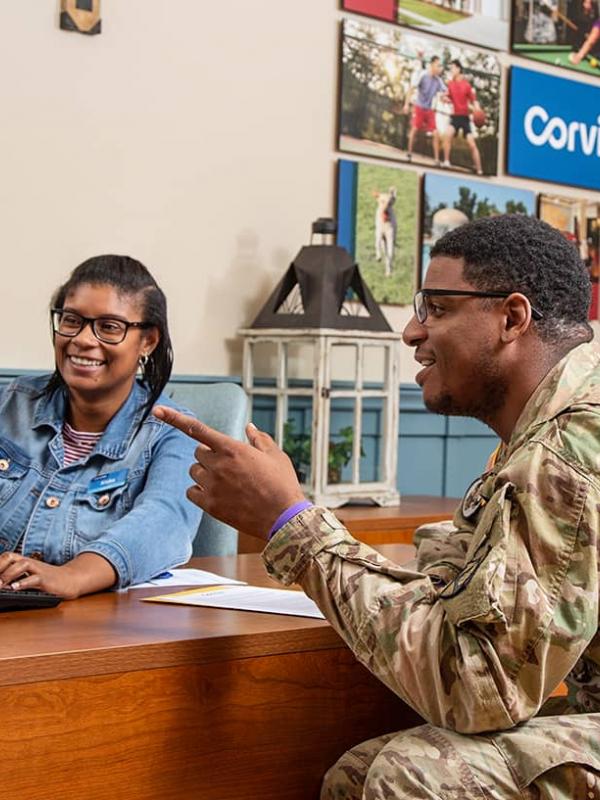 Corvias employee speaking with a solider