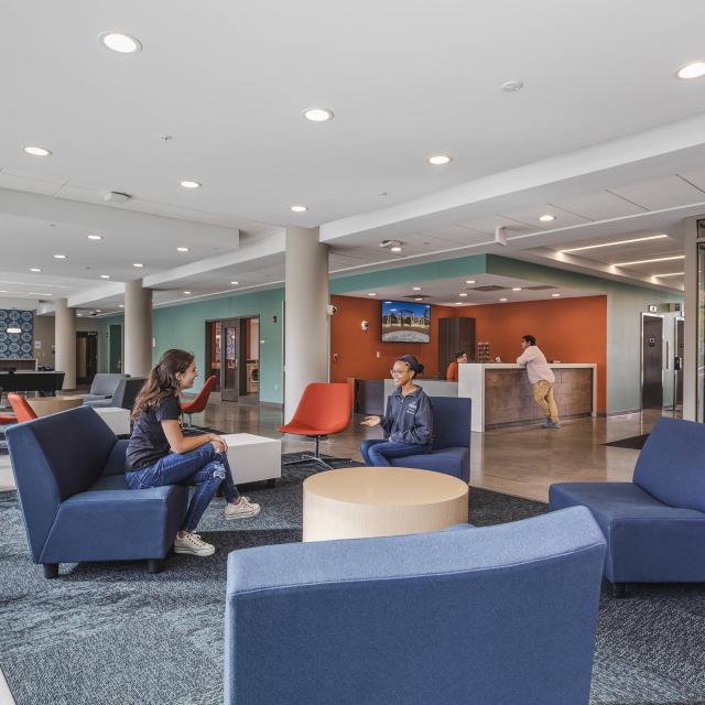 Students sitting in a residence hall lobby