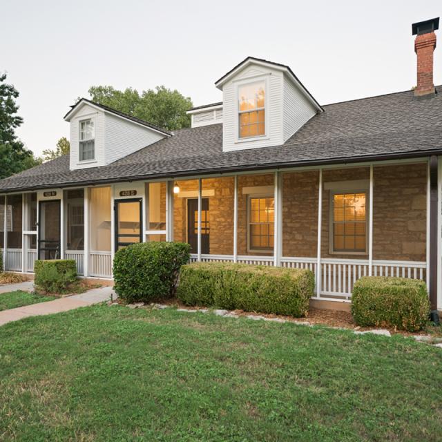 Outside of a house with a screened-in porch