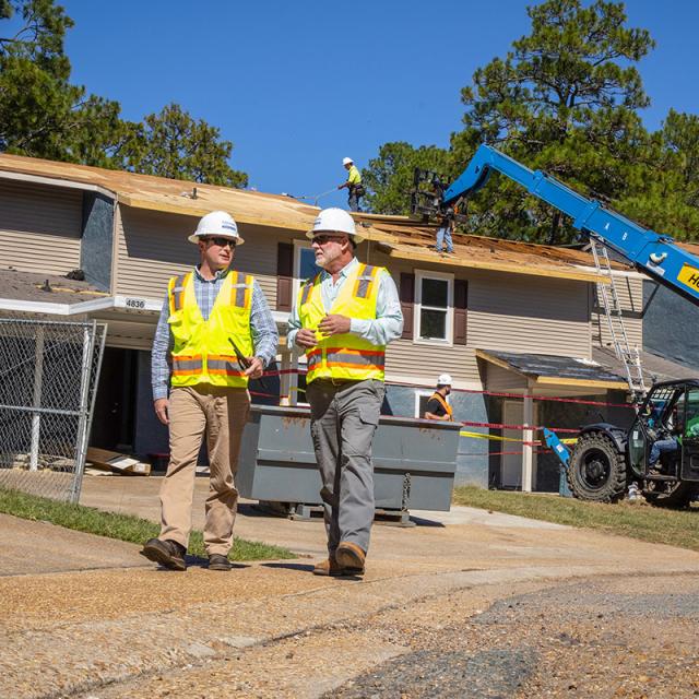 Corvias team members discuss construction project at job site