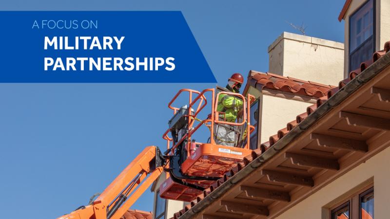 Construction crew repairing the roof of a historic home at Fort Sill