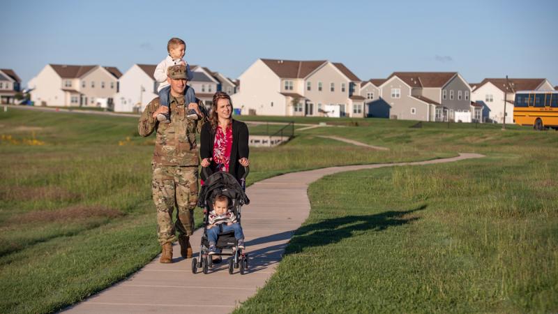 Parents with two children walking in their community