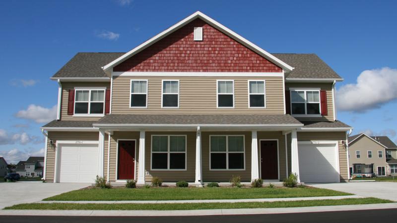 Duplex with tan and red siding