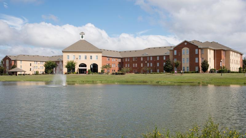 A building behind a large pond