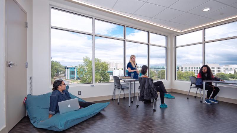 Students sitting and working in an open room