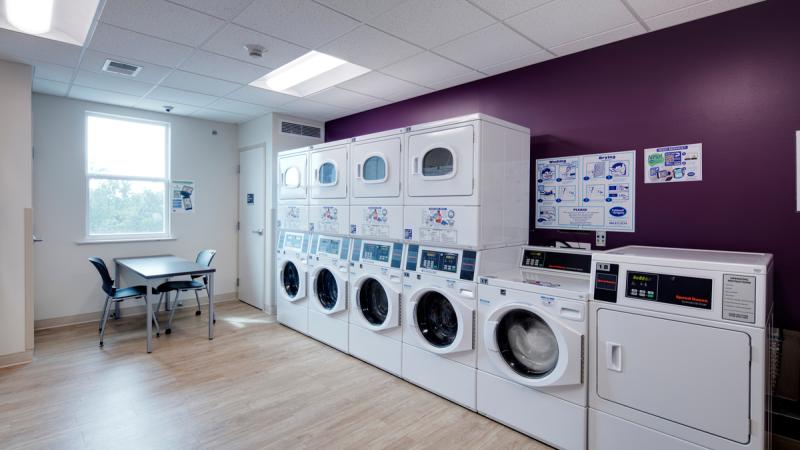 Laundry room with washing machines and dryers