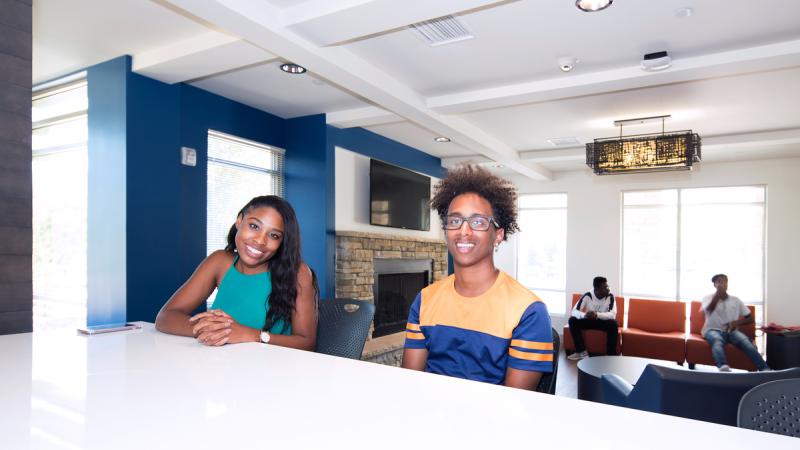 Students sitting a table and smiling