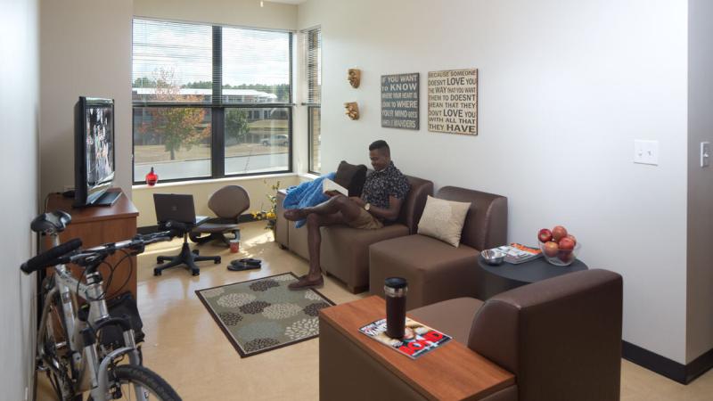 Student sitting in an apartment living room