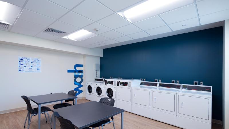 Communal laundry room with washers and dryers