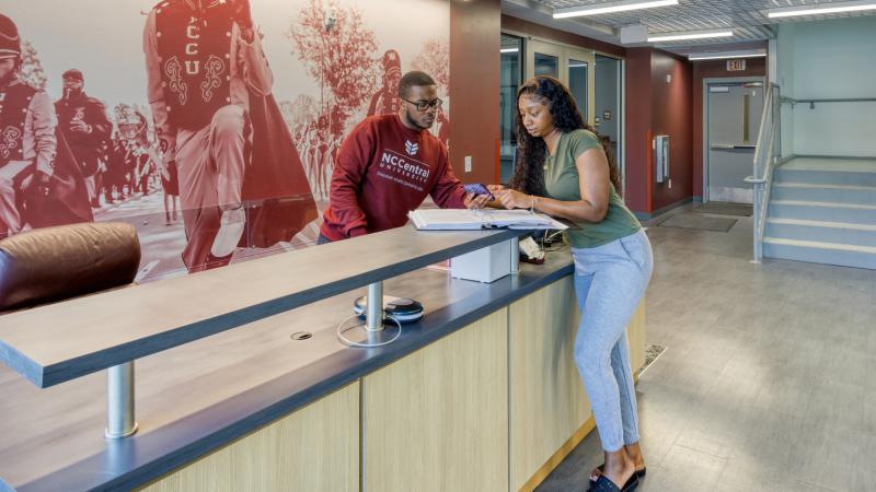 Students talking at a help desk