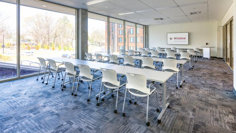 Classroom with long desks and chairs