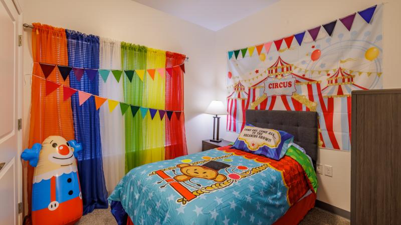An apartment bedroom with a circus theme