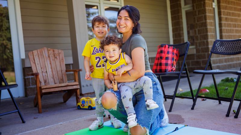 A mom and two children playing outside