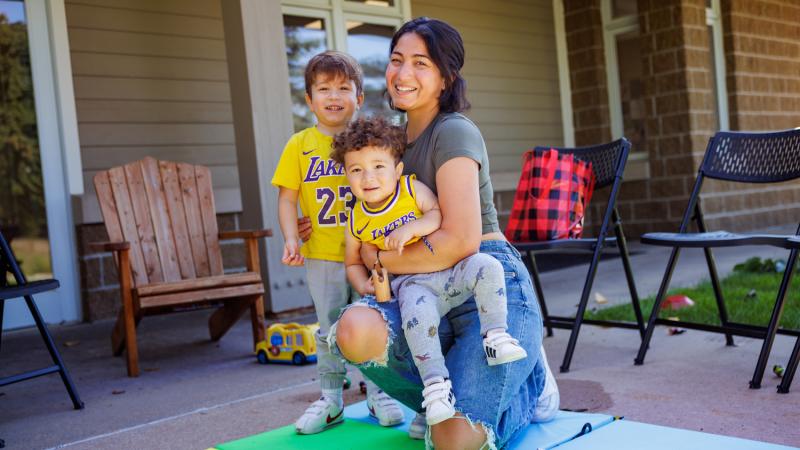 A mom and two children playing outside