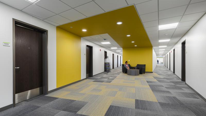 A apartment building hallway with seating