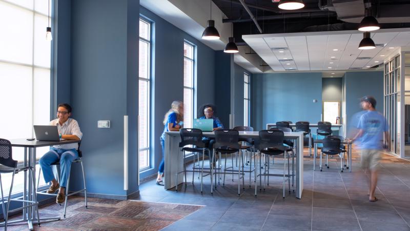 Students working at desks in a shared space