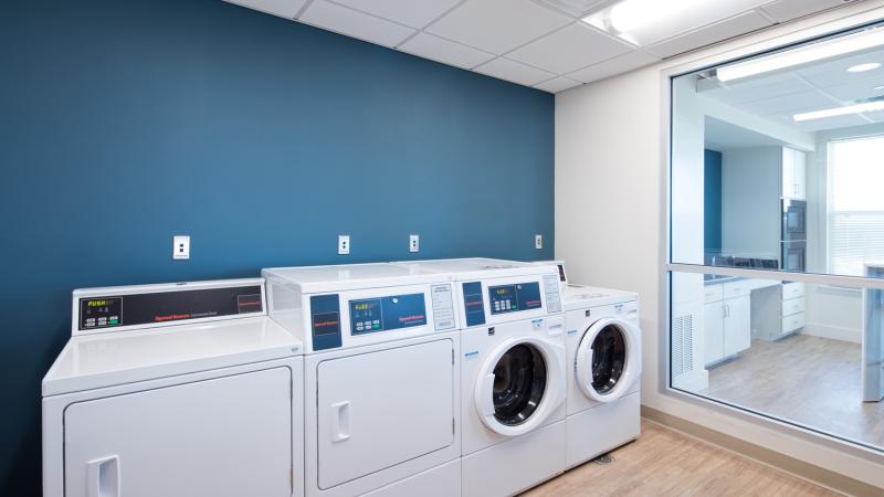 Laundry room with washing machines and dryers