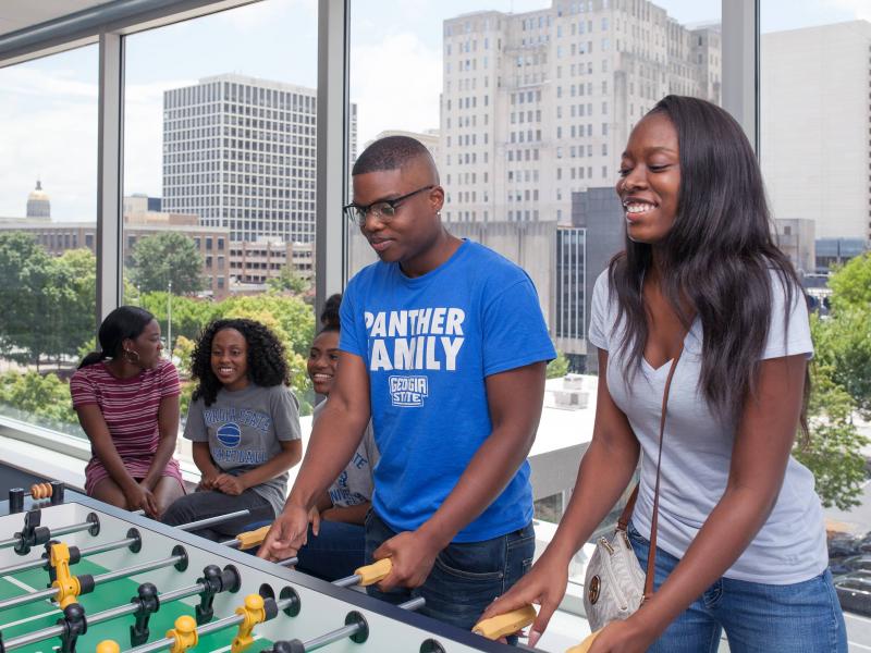 Students playing foosball