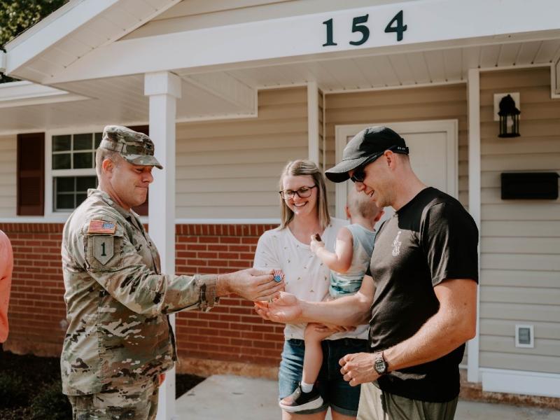 ​  SSG Jared Wise, attending Warrant Officer Career College – WOCC at Fort Rucker, his wife Tiffani Wise and son Aiden Wise tour their newly renovated home at Munson Heights. Built in the 1950s, the 108 Munson Heights duplex homes received major renovations to reflect a more contemporary, open floor plan. ​
