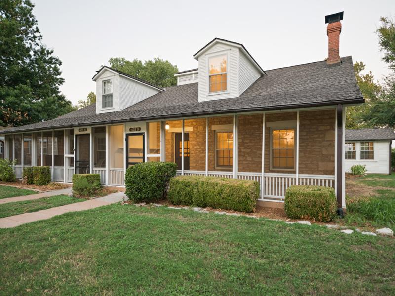 Outside of a house with a screened-in porch