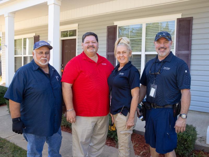 Corvias team members outside military house