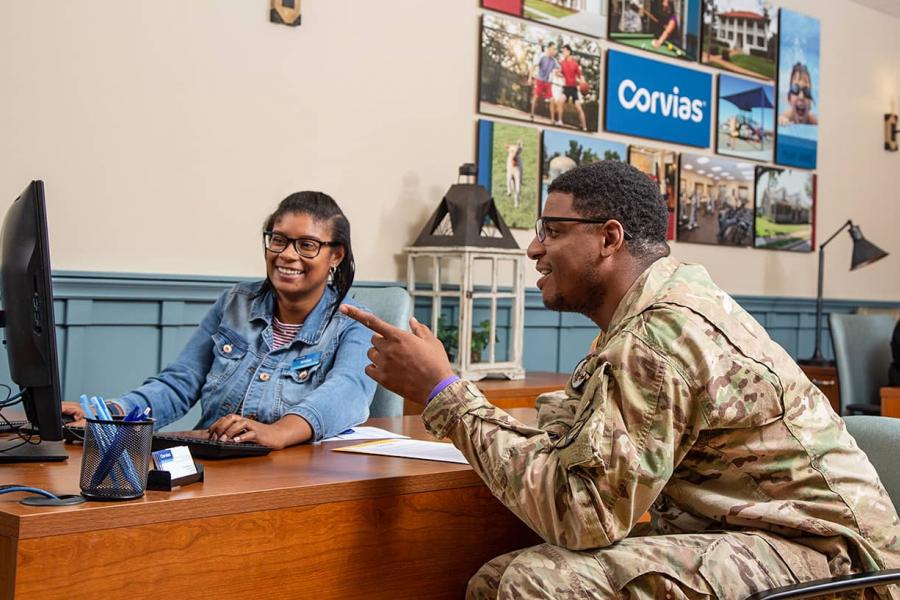 Solider at a leasing office looking at available property