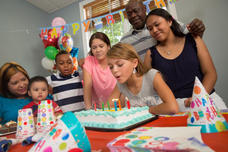 Family celebrating a birthday in a Corvias community center