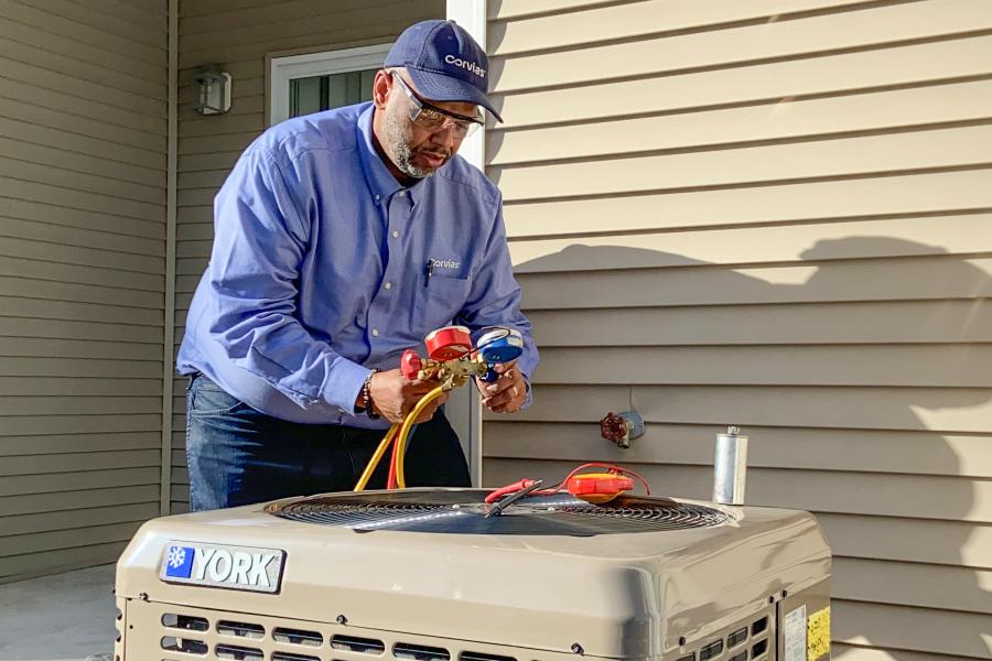 Corvias team member installs a new energy-efficient HVAC system as part of the $325 million Solutions Investment by Corvias to enable energy resilience and modernization across six U.S. Army installations.