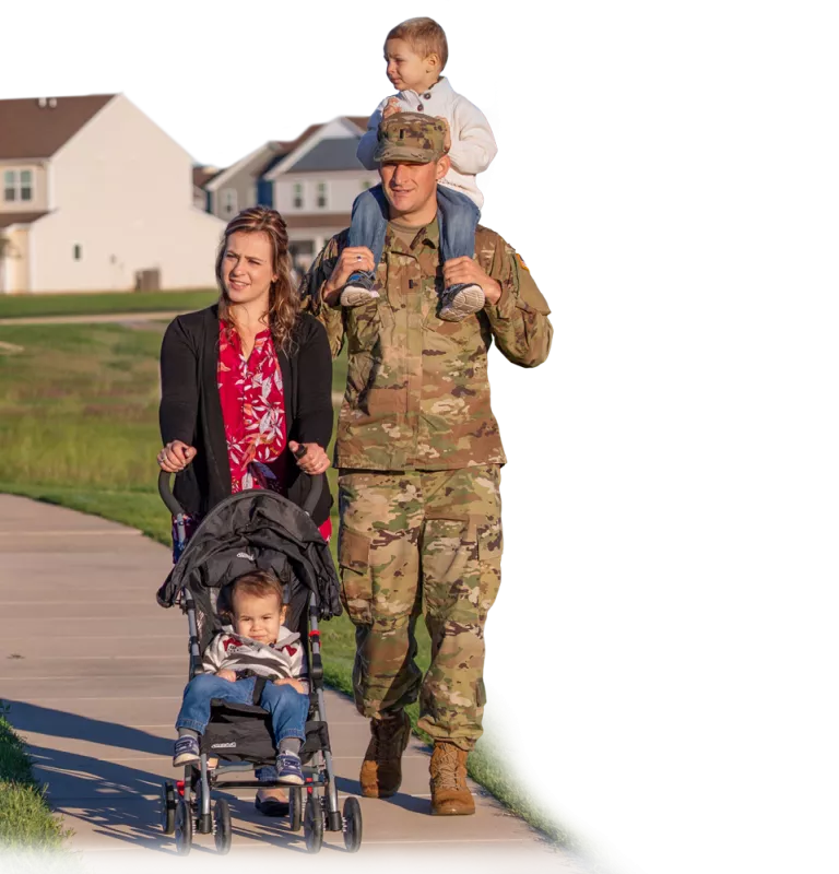 Military Family standing in front of a new house