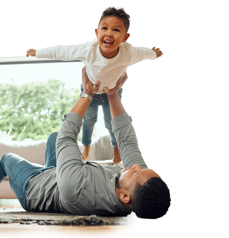 Child being put on an airplane in living room