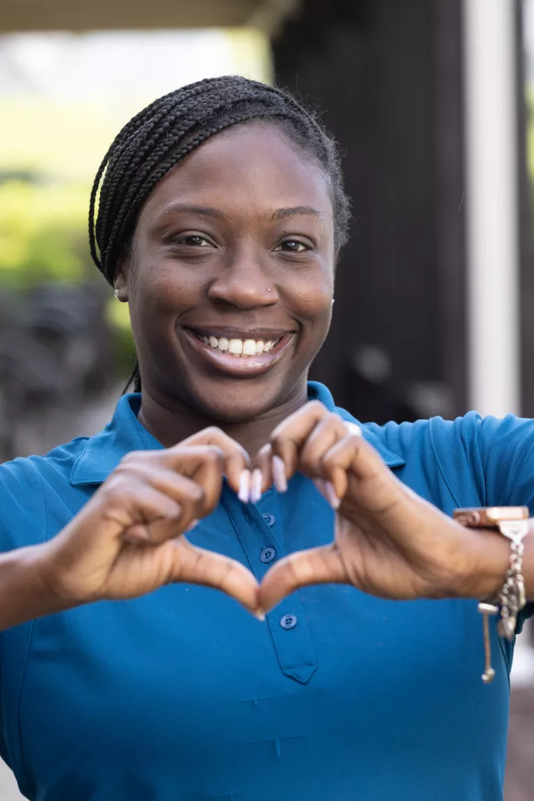 Woman giving a heart symbol