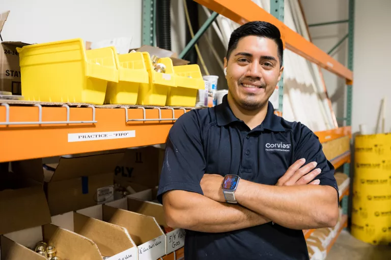 Man standing smiling in front of shelves