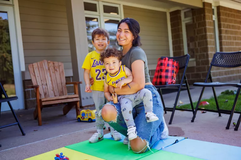A mom and two children playing outside