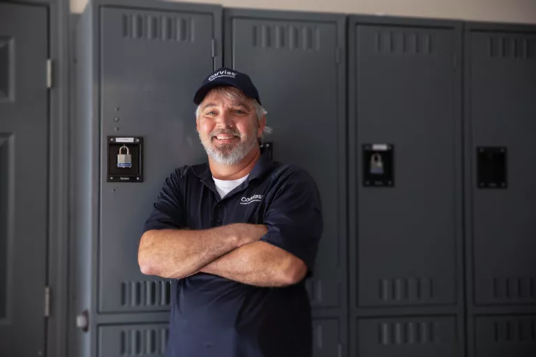 John standing in front of work lockers